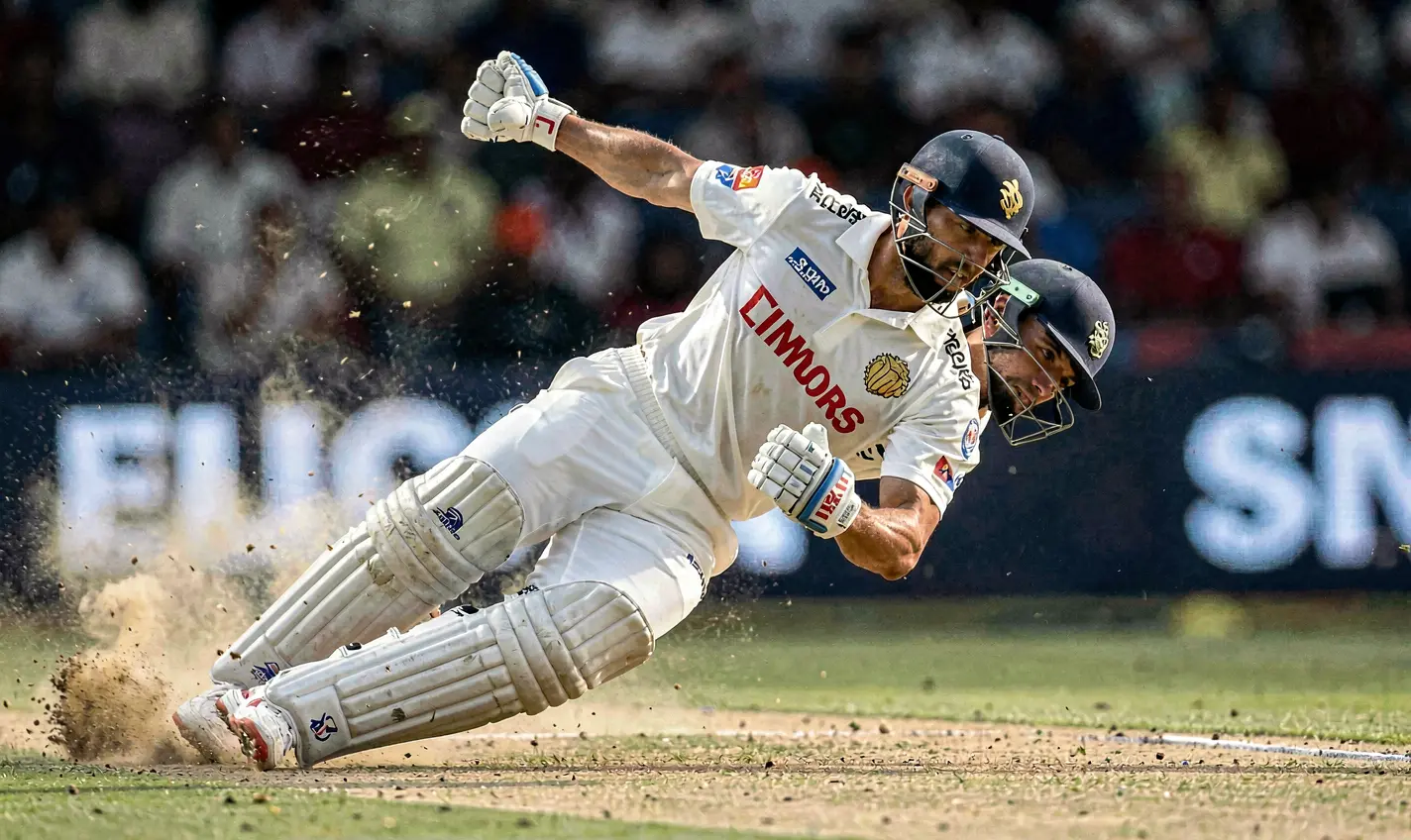 Dynamic slow motion moment of a cricket batsman diving to make a crucial play highlighting intense match action for 388TK betting in Bangladesh